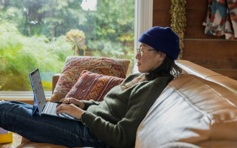 a person sitting at a table using a laptop